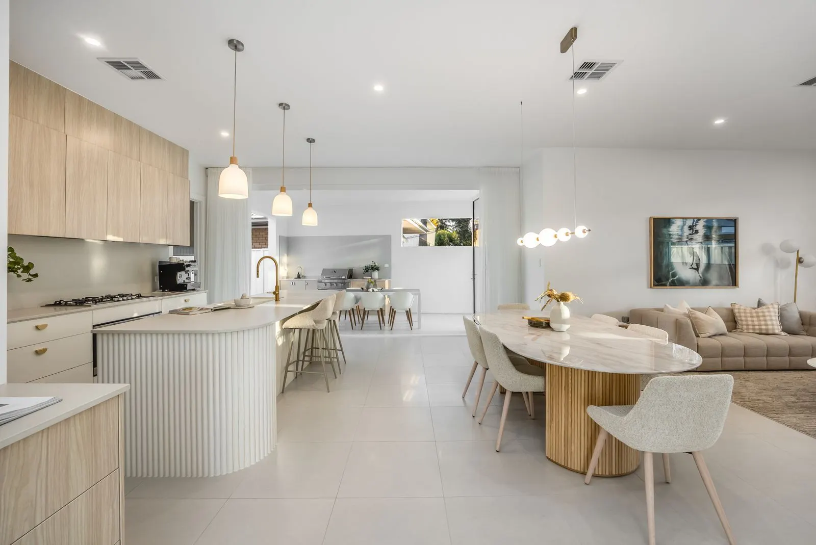 Light kitchen with fluted island and dining area