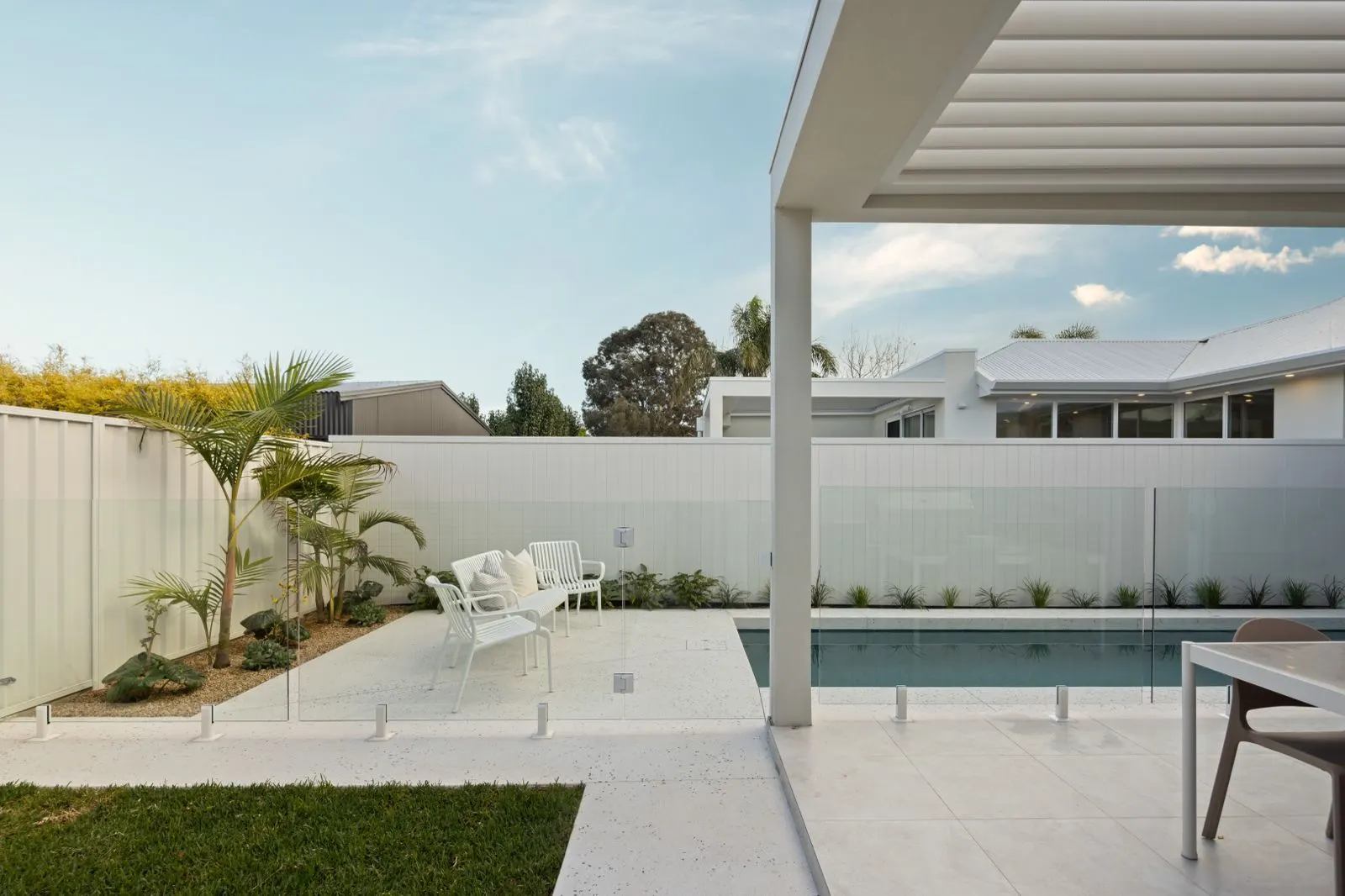 Pool courtyard with glass fencing and seating